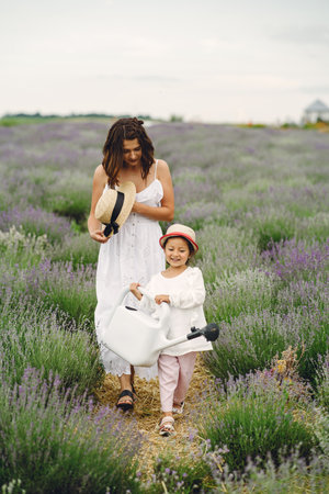 Little girl with her mother in a lavender fieldの写真素材