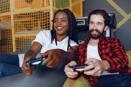 International couple playing a video gamesの写真素材