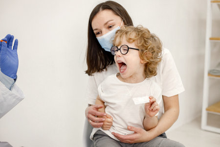 Little boy screaming because doctor is going to do vaccinationの写真素材