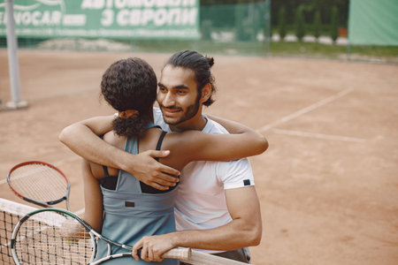 Two tennis players hugging after the matchの写真素材