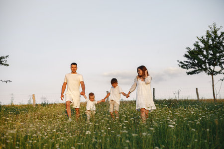 Cute family playing in a summer fieldの写真素材