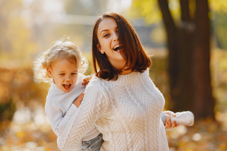 Cute and stylish family in a autumn parkの写真素材