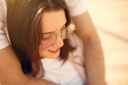 Beautiful couple spend time on a summer parkの写真素材