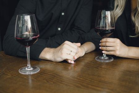 Romantic couple drinking wine at restaurantの写真素材