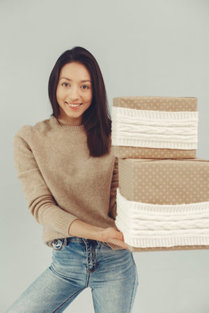 Beautiful girl standing in a studio with presentsの写真素材