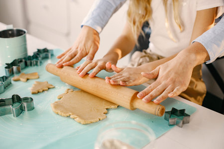 Cropped photo of a womens hands roll out the dough