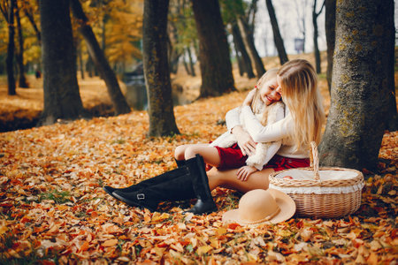 Cute and stylish family in a autumn parkの写真素材