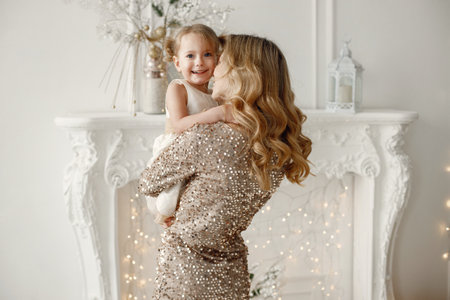 Mom and daughter playing together in white sudioの写真素材