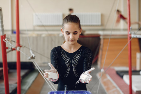 Midsection of a female gymnast applying white powder to handsの写真素材