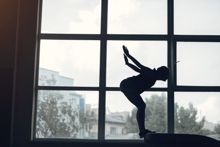 Prepare young child athlete gymnast on balance beamの写真素材