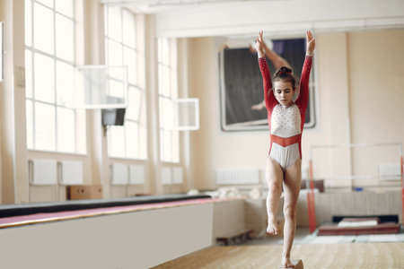 Prepare young child athlete gymnast on balance beamの写真素材
