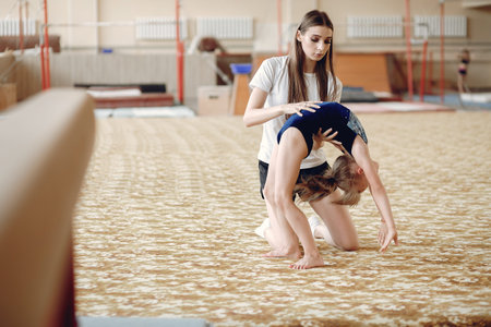 Lovely little girls gymnasts training in a athletics class