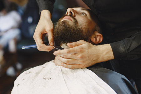 Stylish man sitting in a barbershopの写真素材