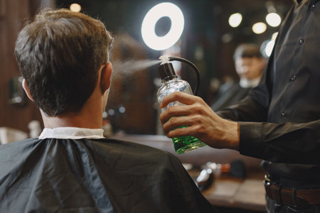 Stylish man sitting in a barbershopの写真素材