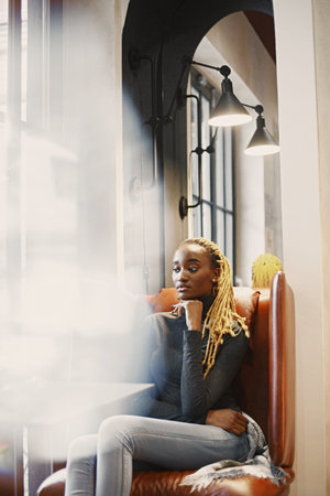 African woman sitting in a cafeの写真素材