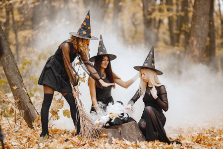 Three witches in forest on Halloween make magic potionの写真素材