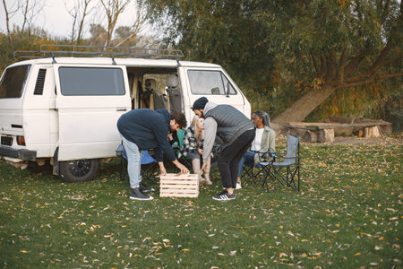 Two men carrying crate with logsの写真素材