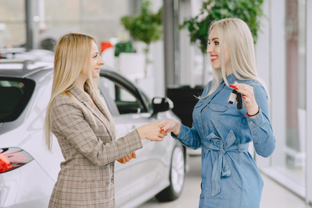 Stylish and elegant women in a car salonの写真素材