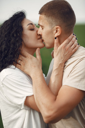 Beautiful couple spend time on a summer fieldの写真素材