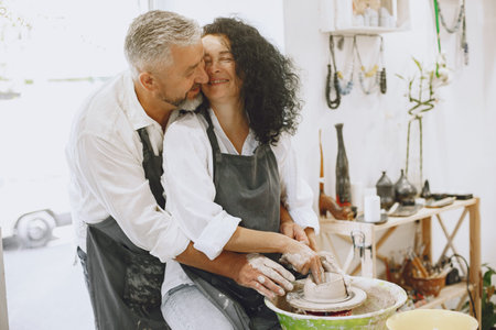 Adult senior couple at artwork in pottery