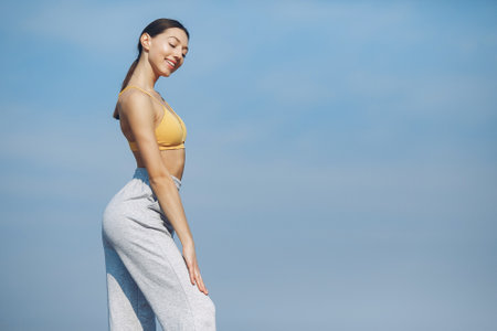 Cute girl training on a sky backgroungの写真素材