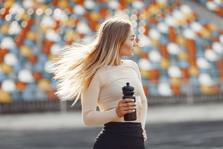 Sports girl in a uniform standing at the stadium