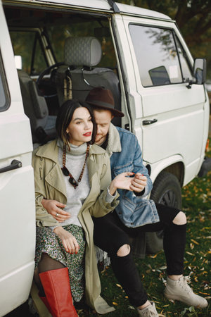 Stylish couple sitting and posing for a photoの写真素材