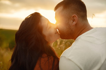 Beautiful couple spend time on a summer field
