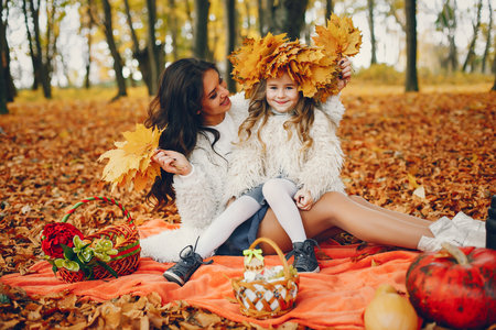 Cute and stylish family in a autumn parkの写真素材