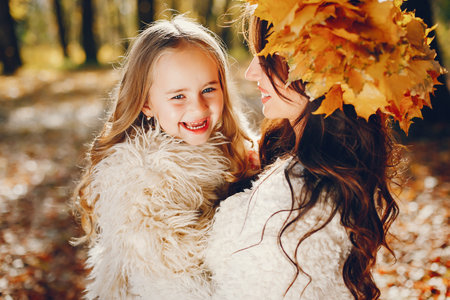 Cute and stylish family in a autumn parkの写真素材