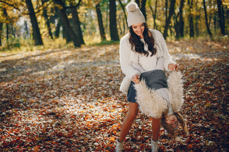 Cute and stylish family in a autumn parkの写真素材