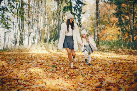 Cute and stylish family in a autumn parkの写真素材