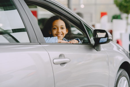 Cute african girl in modern car dealershipの写真素材
