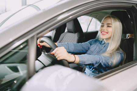 Stylish and elegant woman in a car salonの写真素材
