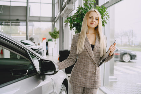 Stylish and elegant woman in a car salonの写真素材