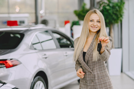 Stylish and elegant woman in a car salonの写真素材