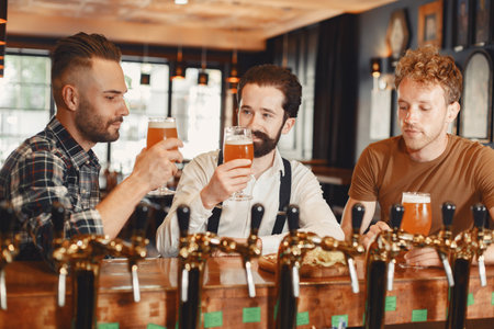 Three men in shirts in the bar.の写真素材