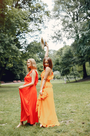 Elegant and stylish girls in a summer parkの写真素材