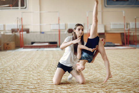Lovely little girls gymnasts training in a athletics class