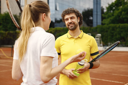 Two tennis players talking on a tennis court before the match
