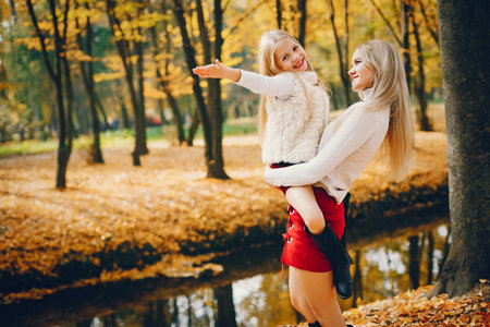 Cute and stylish family in a autumn parkの写真素材