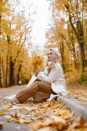 Portrait of a young woman in autumn forestの写真素材
