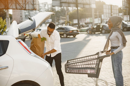Couple pack grocery in a car
