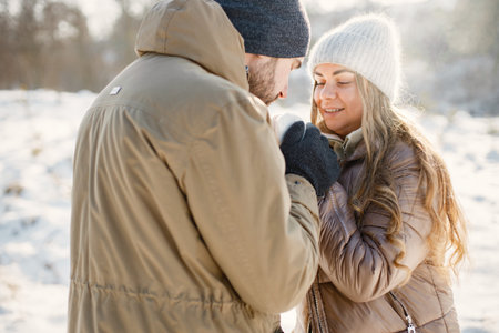 Young man and woman spending time together at winter dayの写真素材