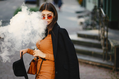 stylish girl smoking an e-cigarette