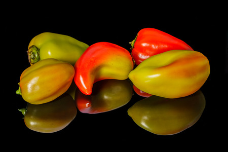 Sweet colorful peppers isolated on black backgroundの写真素材