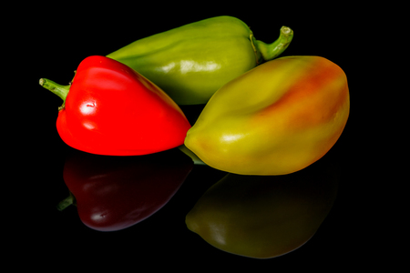 Sweet colorful peppers isolated on black backgroundの写真素材