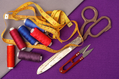 Sewing accessories and fabric close-up. Tailoring scissors and centimeter tape are needed for sewing.の写真素材