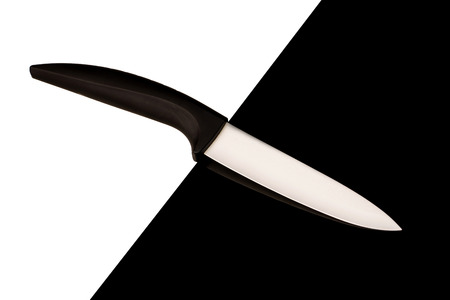 Ceramic knife with black handle on black and white backgroundの写真素材