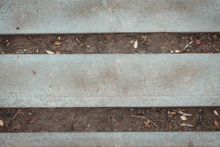 Nature and civilization interaction Background texture. Stone, asphalt, concrete horizontal stripes and dry empty ground. Copy space text. Gray color industrial backdrop. Old surface parallel lines.の写真素材